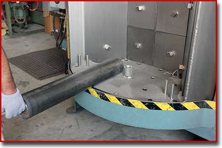 loading roller can into Spinner hanger grit blast chamber